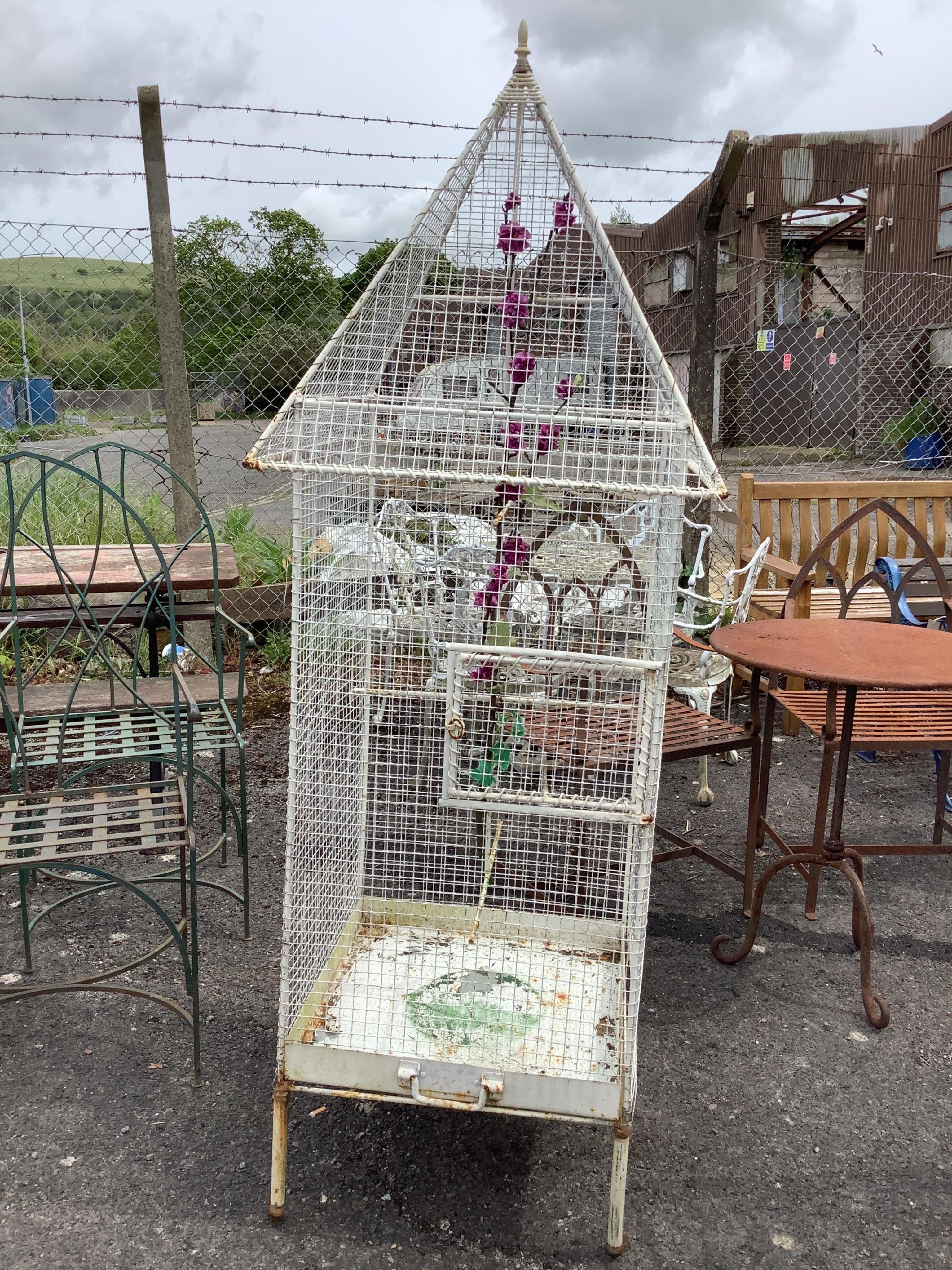 A painted wrought iron and wirework birdcage, width 62cm, height 180cm